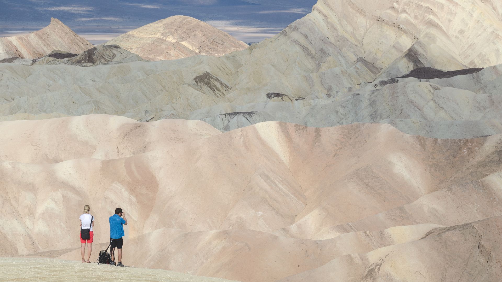 View from Zabriskie Point on Manly Beacon in Death Valley with two (photographing) people