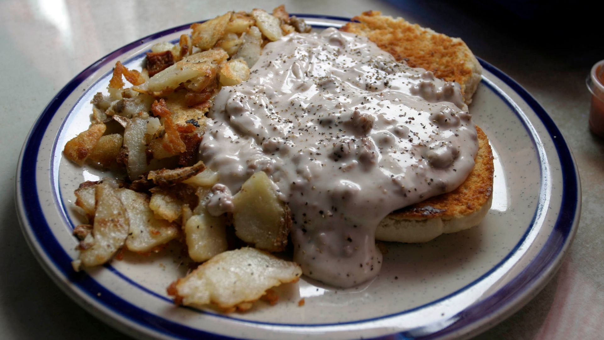 Picture of Biscuits and gravy, with a side order of home fries.  Image taken by the author at Daddypop's Tumble Inn Diner in Claremont, NH, USA.