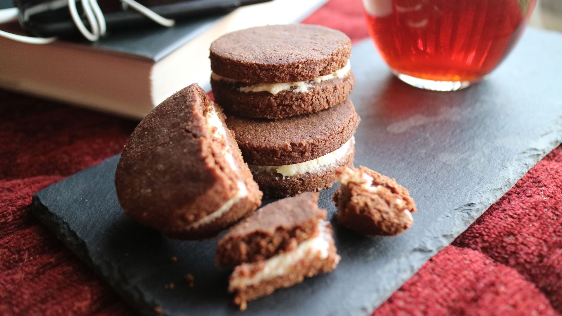 Delicious homemade chocolate biscuits paired with a warm cup of tea, perfect for a cozy afternoon.