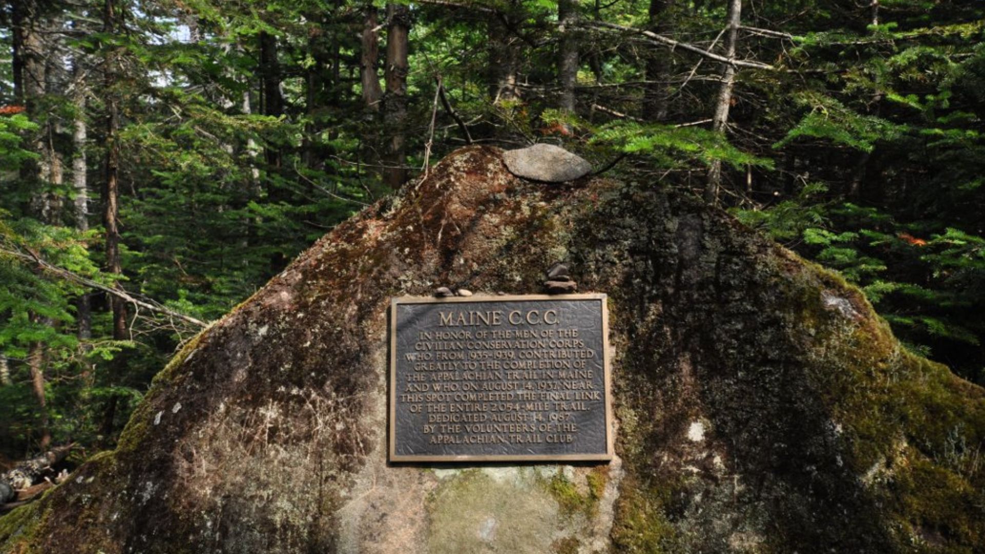 This marker stands on the Appalachian Trail between Mounts Spaulding and Sugarloaf in Maine, in commemoration of the trail's completion by a CCC crew in 1937.  It reads