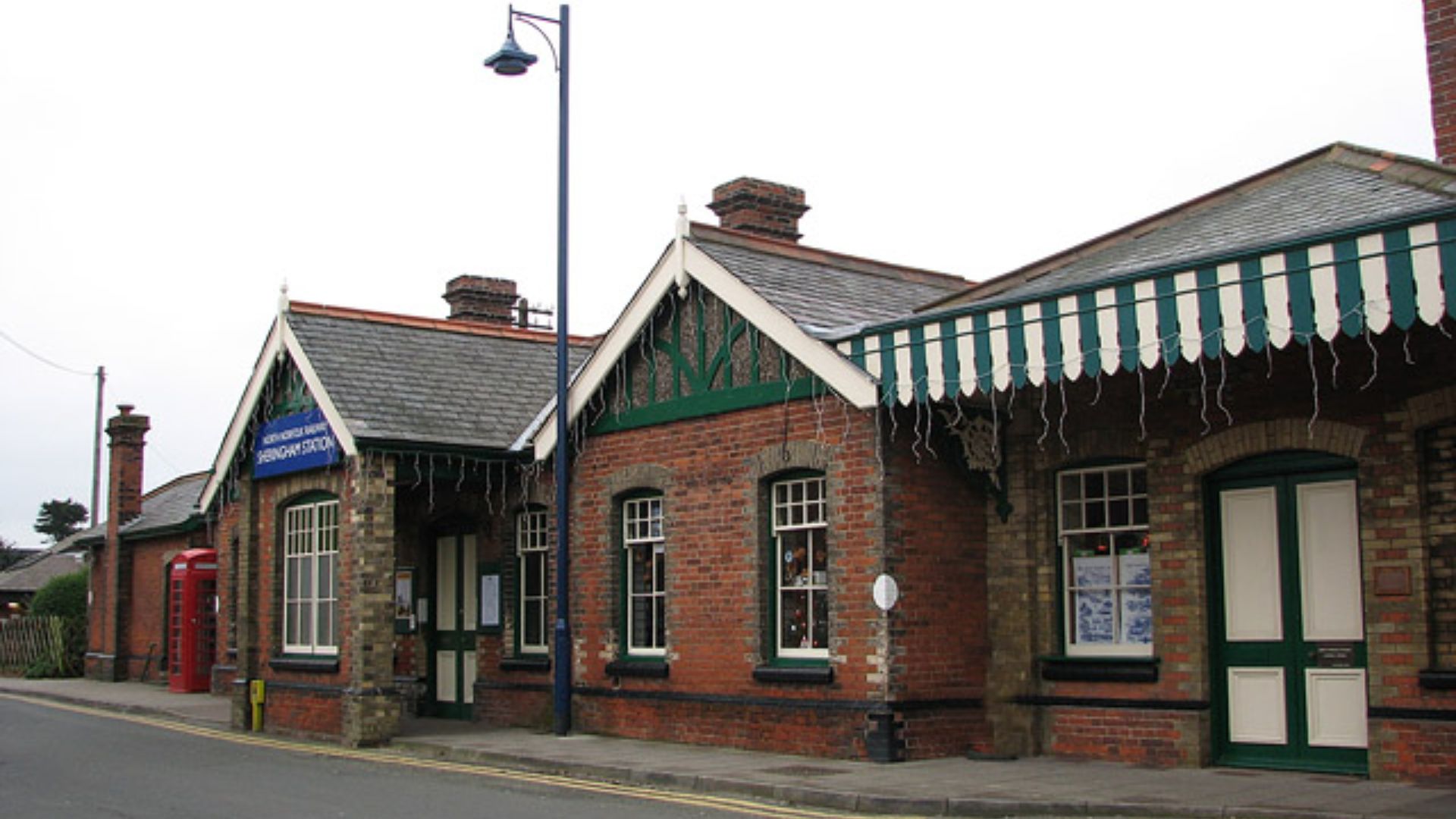 The old railway station - frontage. Built in the E&M pavilion style, Sheringham railway station > 1091380 opened on 16th June 1887 and was extended in 1896. The exterior of the current station building looks similar to the extended station and the canopy 
