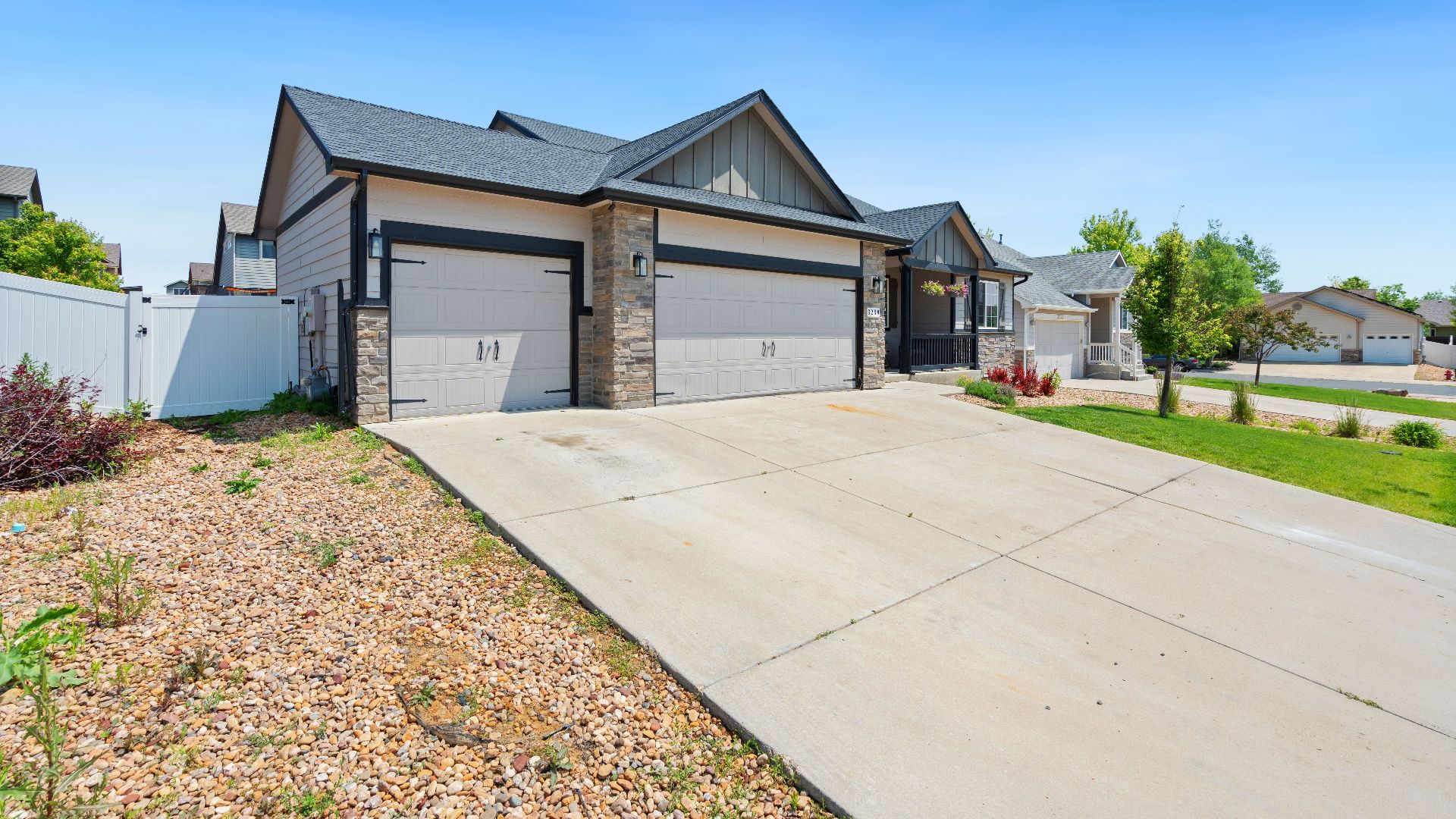 A contemporary suburban house with a large driveway, ideal for family living.