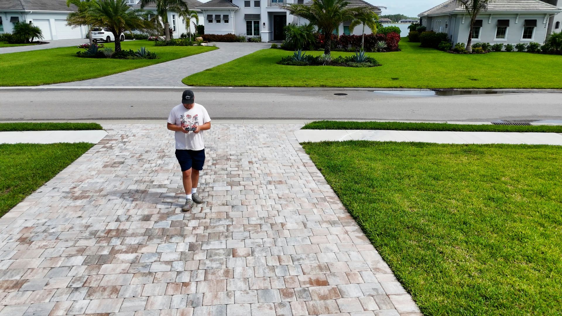 A man running down a sidewalk in a neighborhood