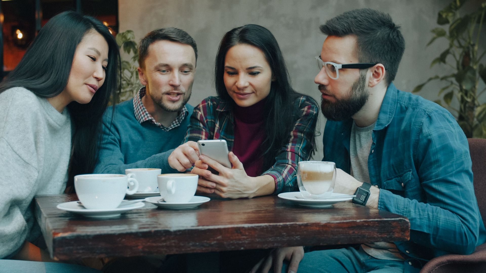 A group of friends enjoying coffee and socializing at a cafe.