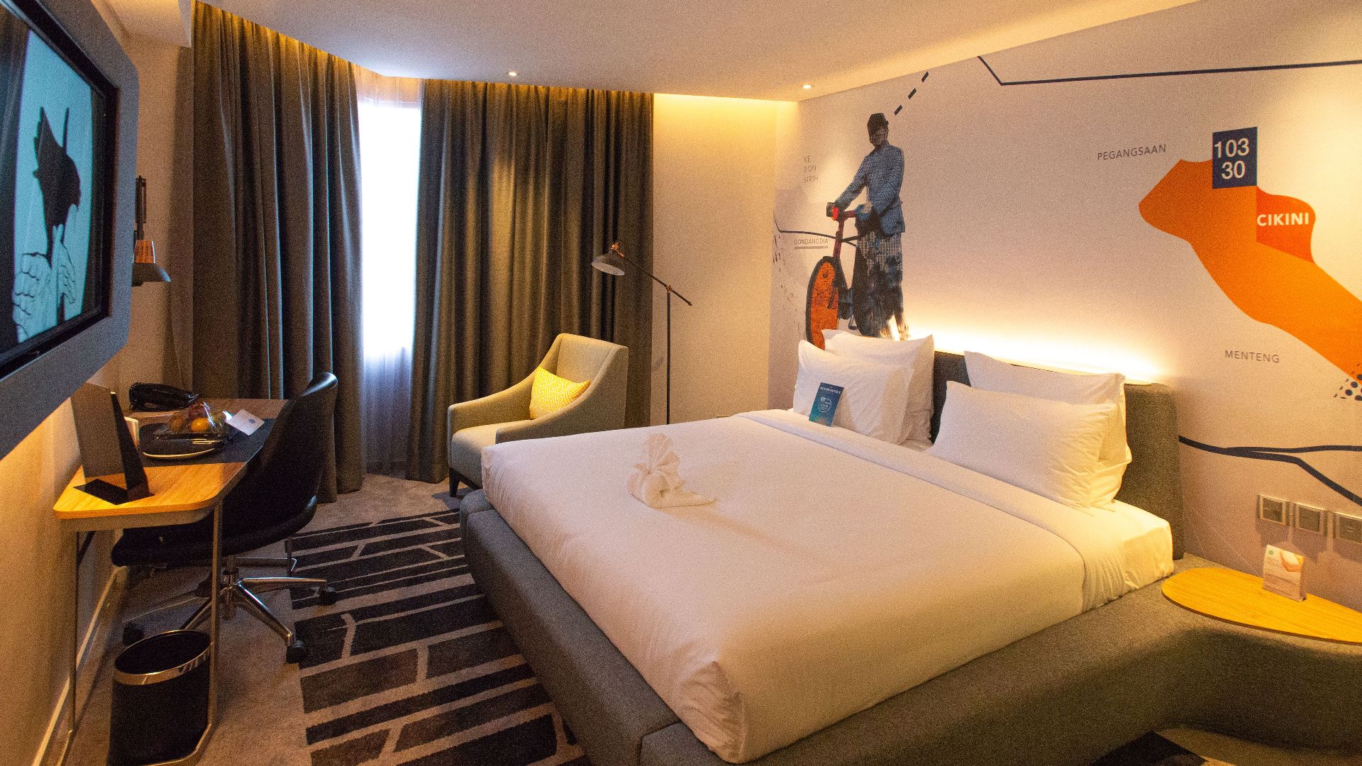 Modern hotel room interior in South Jakarta, offering cozy ambiance with warm lighting and stylish decor.