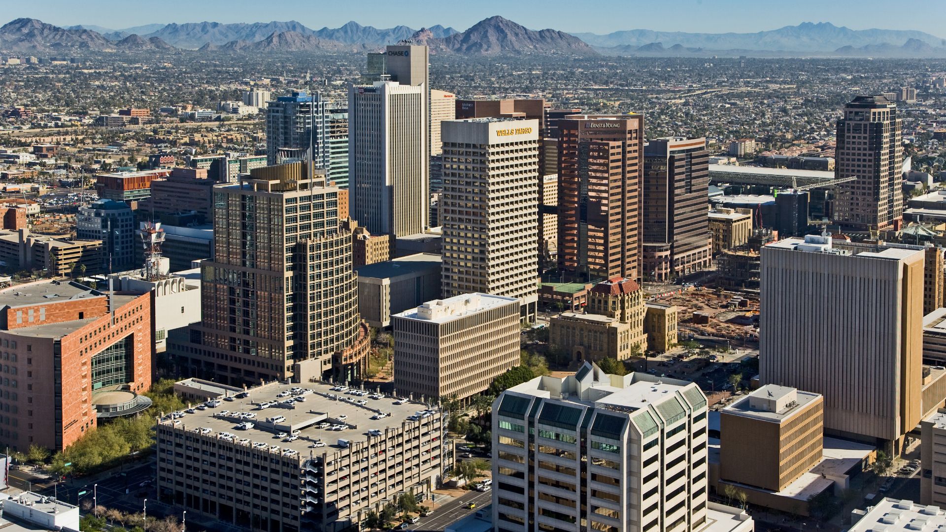 Skyline view of Phoenix — looking northeast from a helicopter, from above the 4th Avenue Jail. 
Foreground is the Central City Village and Central Avenue Corridor of Downtown Phoenix.
In the foreground Municipal and County Courts are visible along with ot