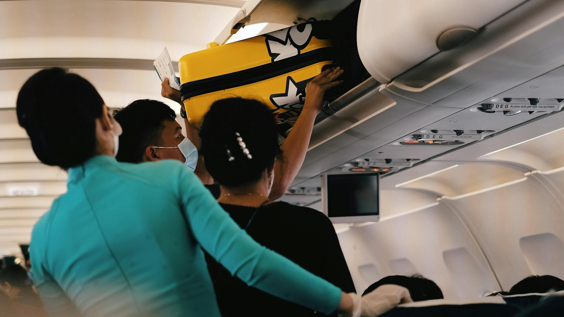 Passengers Storing Their Luggage Inside the Overhead Bin