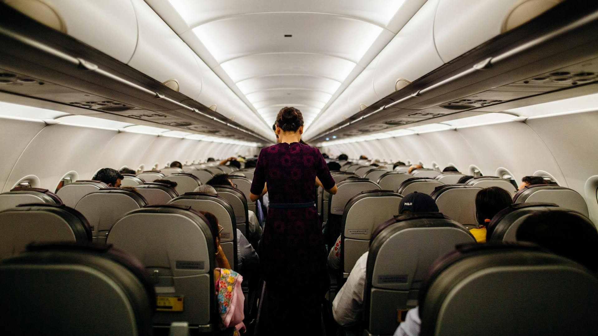 Flight Attendants standing at the Plane Aisle