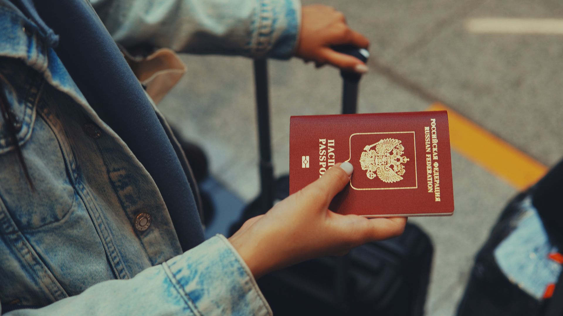 a person holding a red passport in their hand