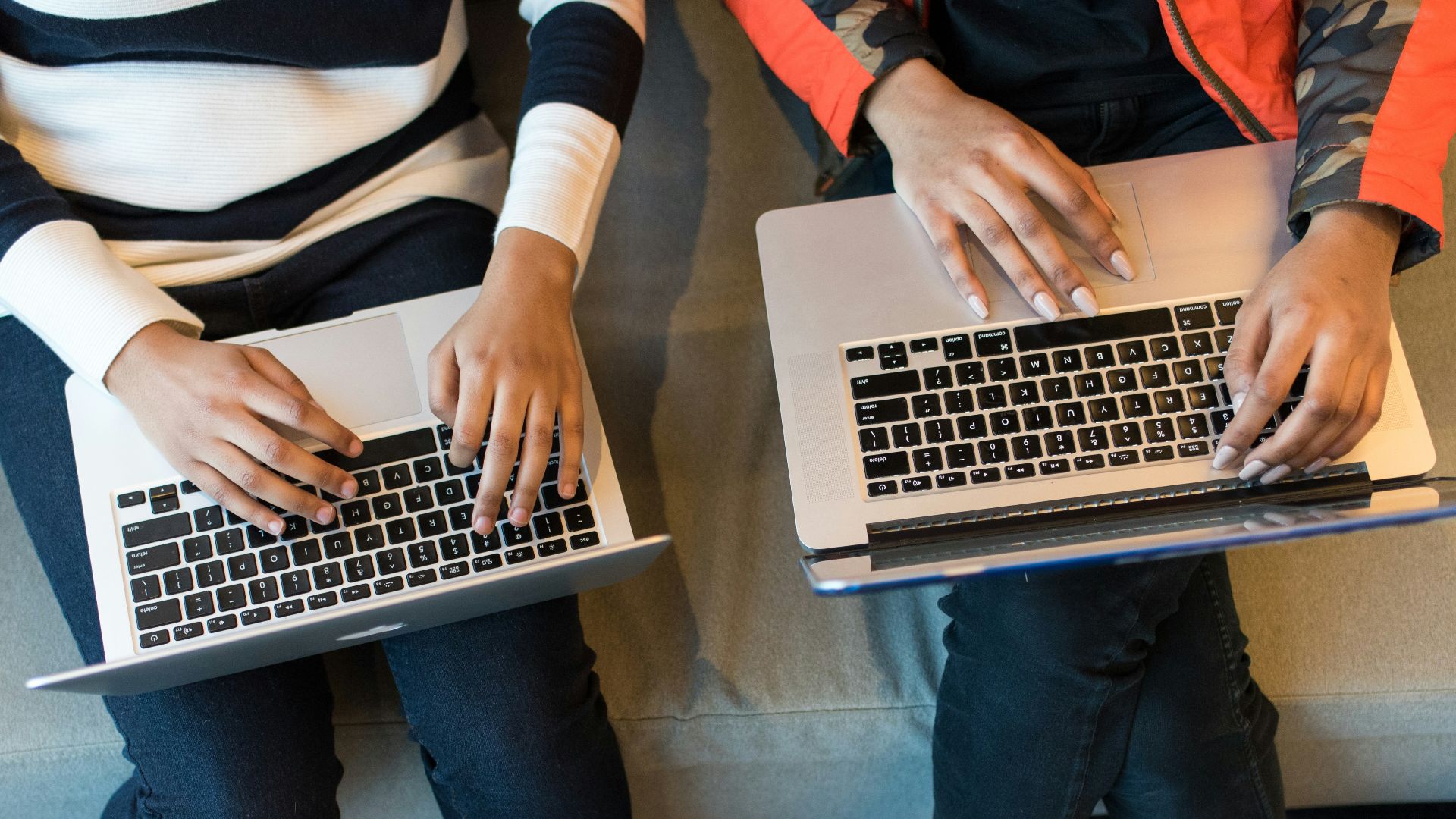 two women using MacBook Pro