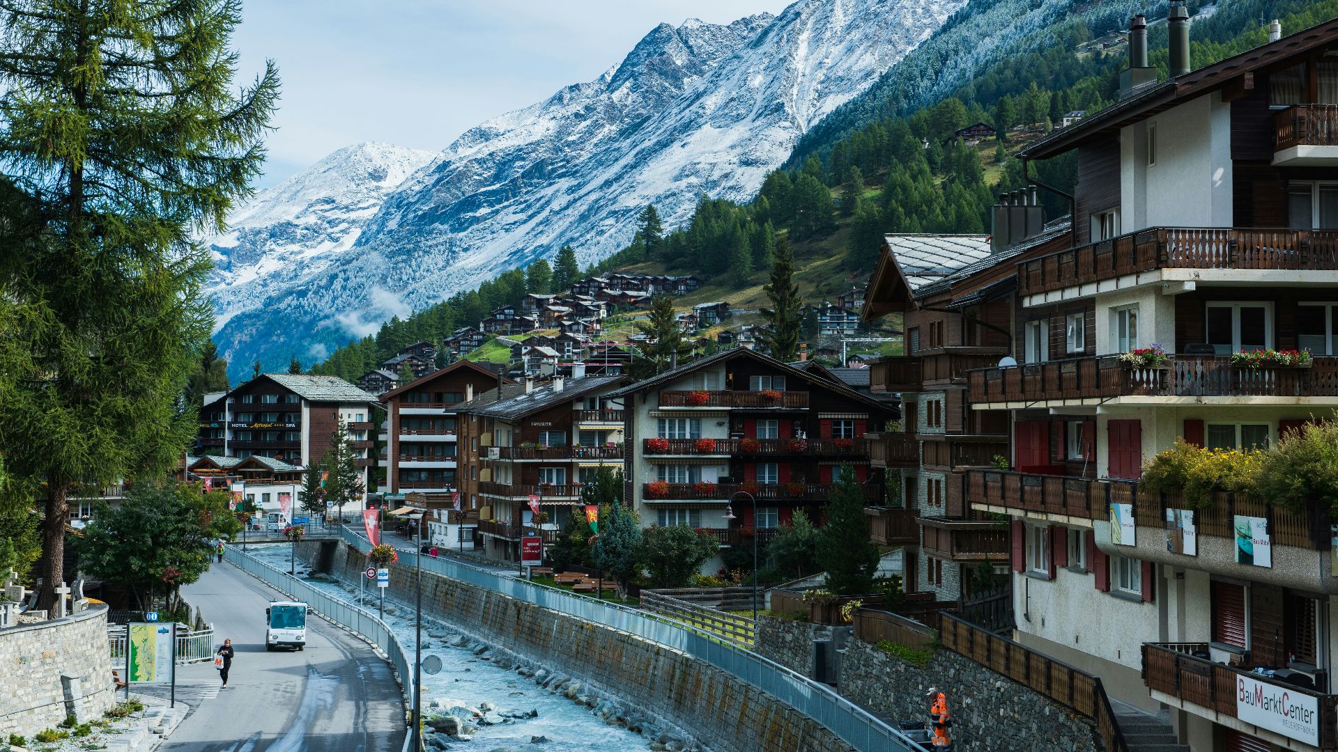 houses near road and mountain under blue sky during daytime photography