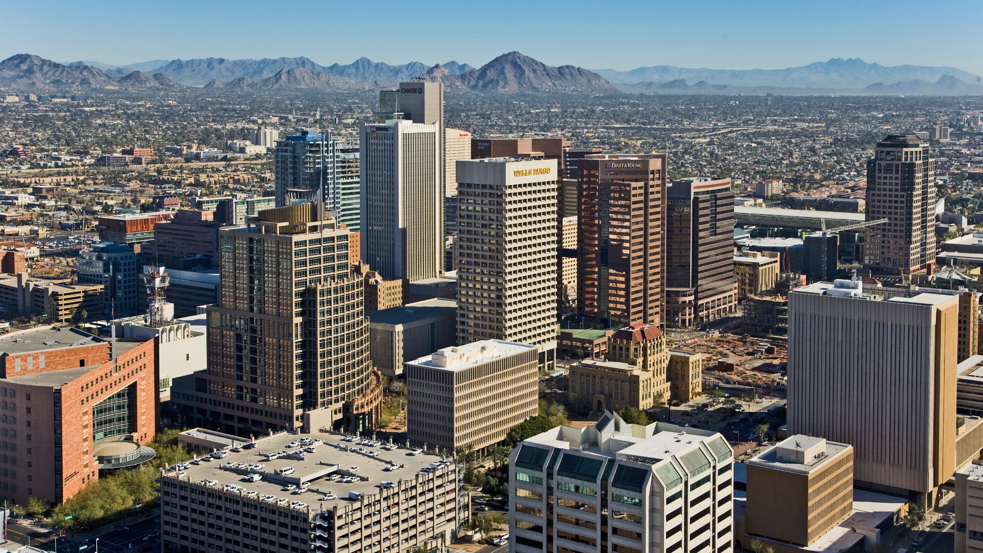 Skyline view of Phoenix — looking northeast from a helicopter, from above the 4th Avenue Jail.
Foreground is the Central City Village and Central Avenue Corridor of Downtown Phoenix.
In the foreground Municipal and County Courts are visible along with ot