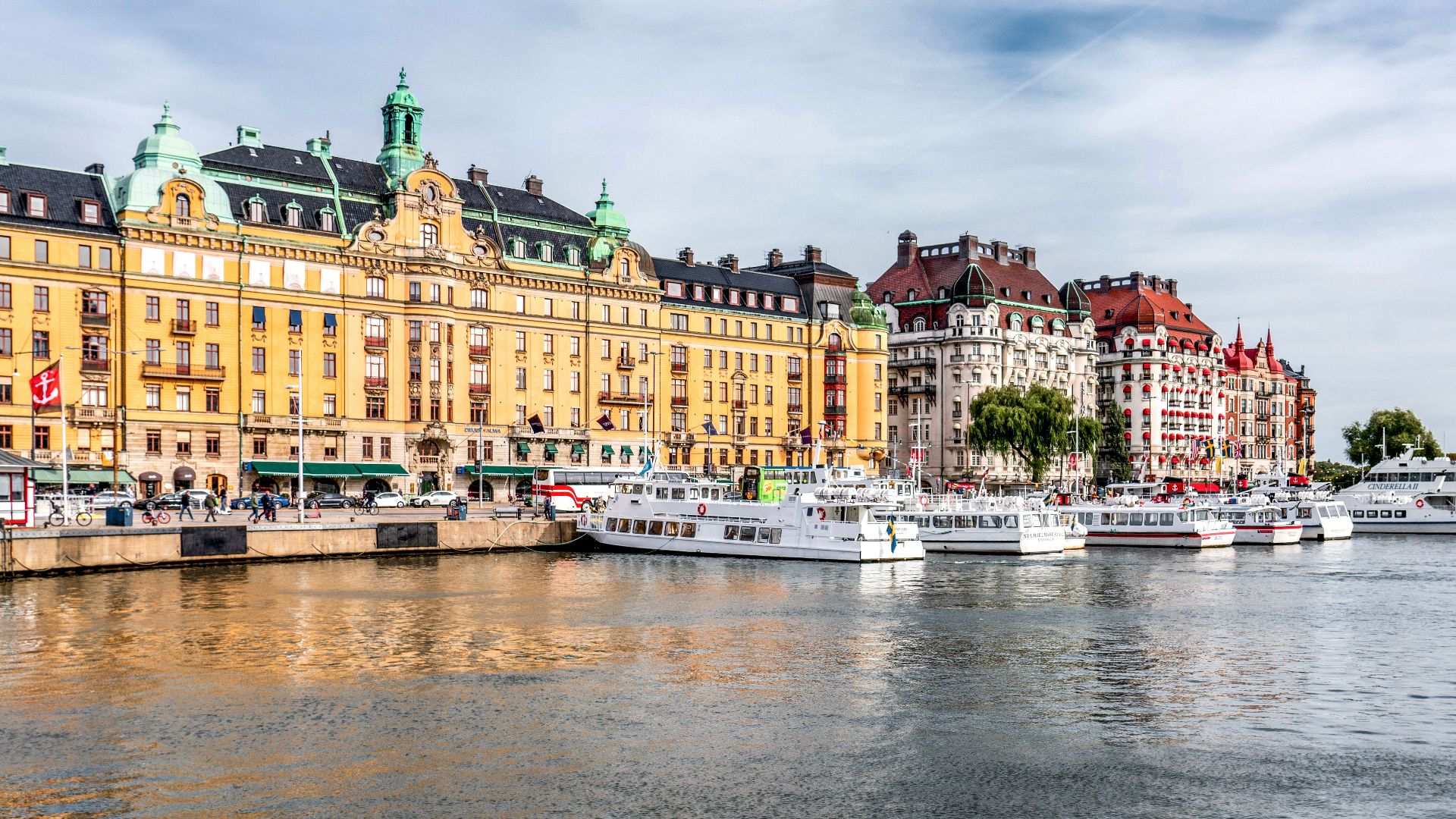 Charming view of Nybroviken, Stockholm with colorful historic buildings and moored boats.