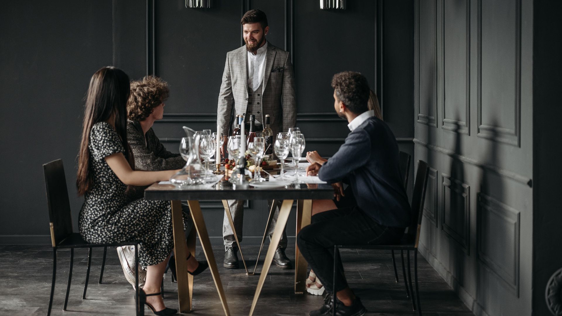 A sophisticated wine tasting event with diverse adults enjoying drinks indoors.