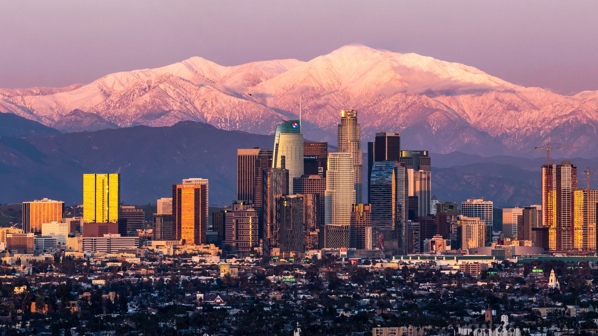 February shot of downtown Los Angeles sunset with Mount Baldy in the background after a large snow storm.