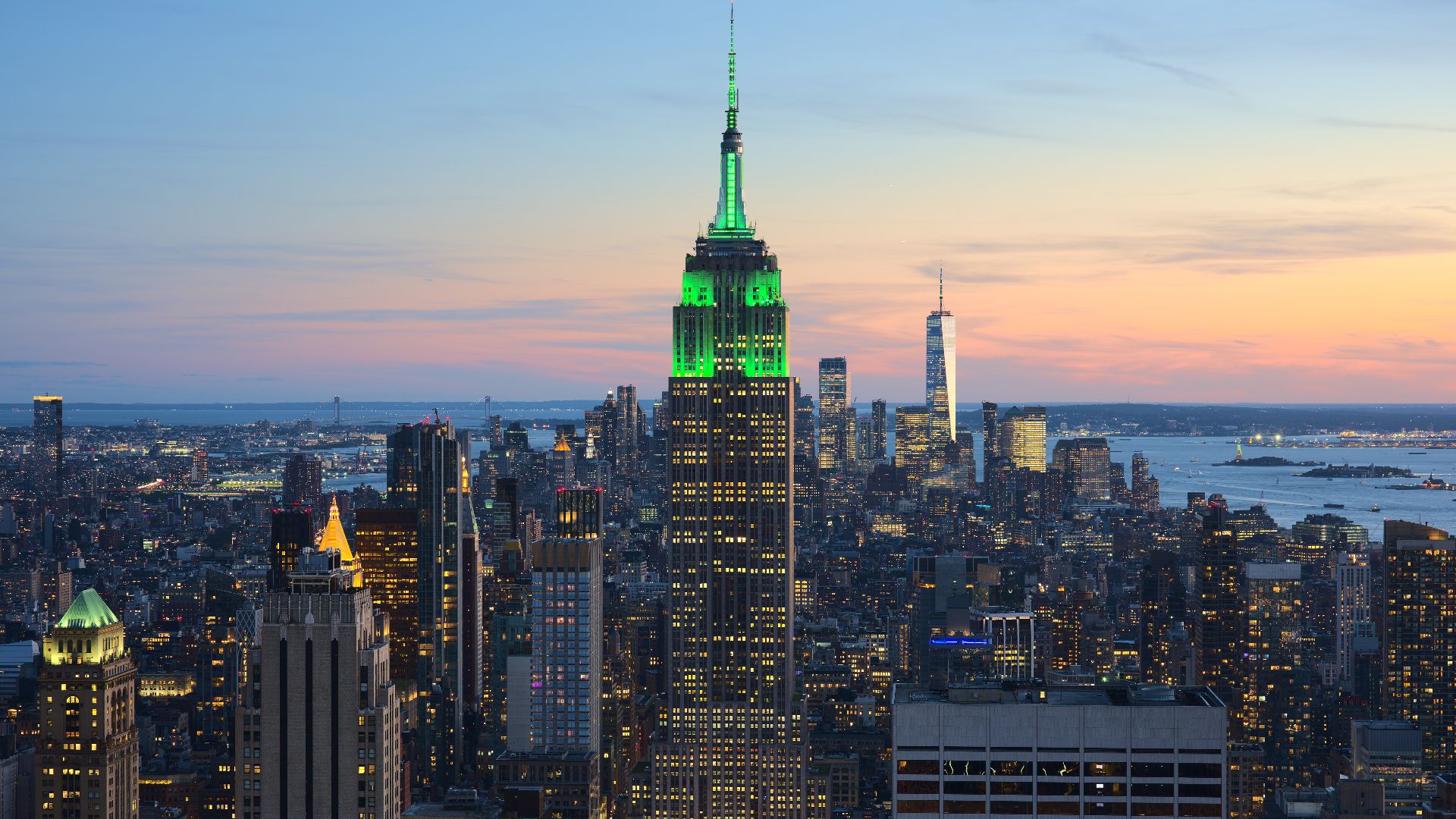 View of the Empire State Building in New York City from the Top of the Rock at 30 Rockefeller Plaza during sunset. The tower was illuminated in green in honor of Climate Week NYC.[1]