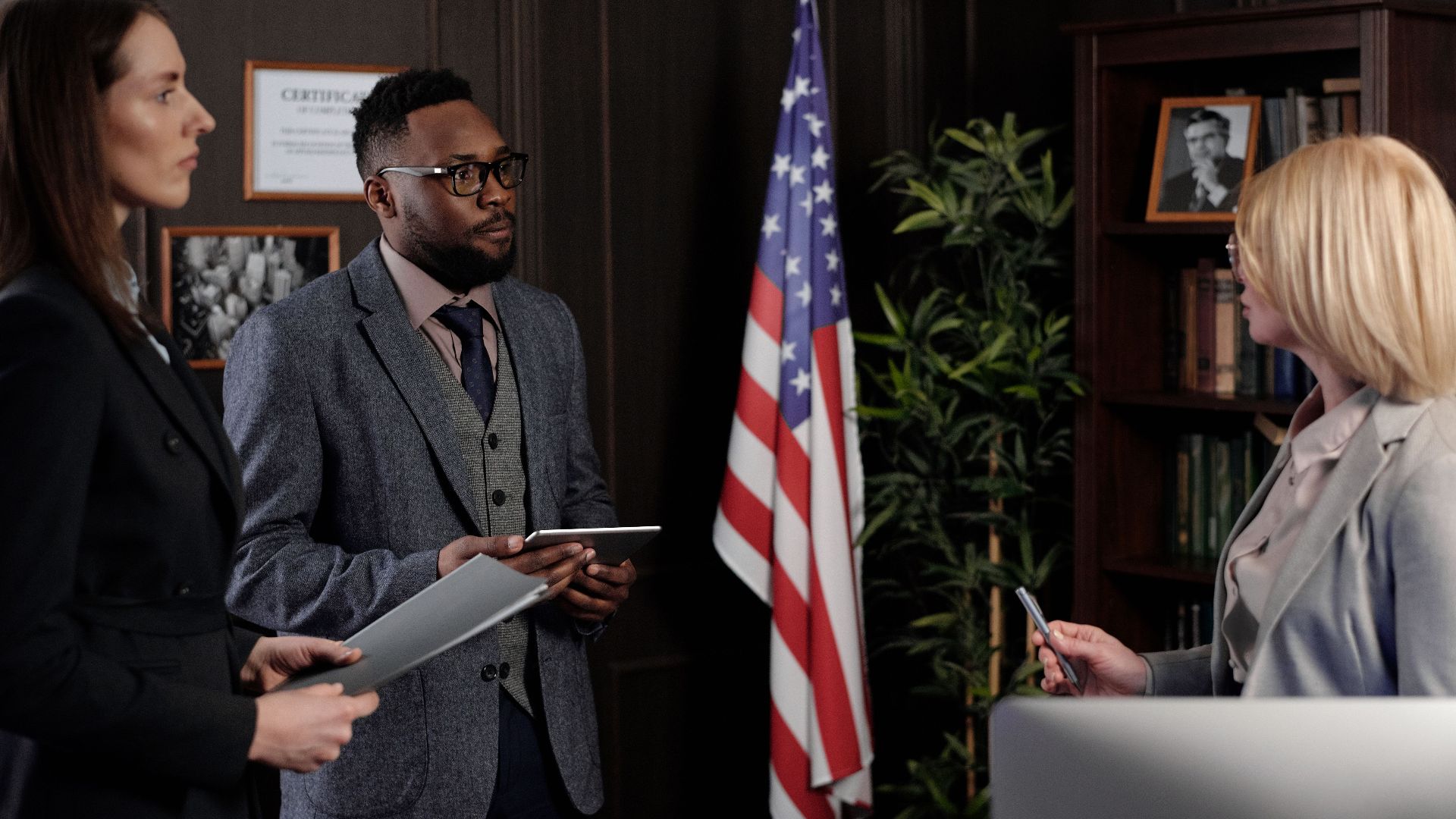 Business professionals in formal discussion, advocating teamwork and diversity.