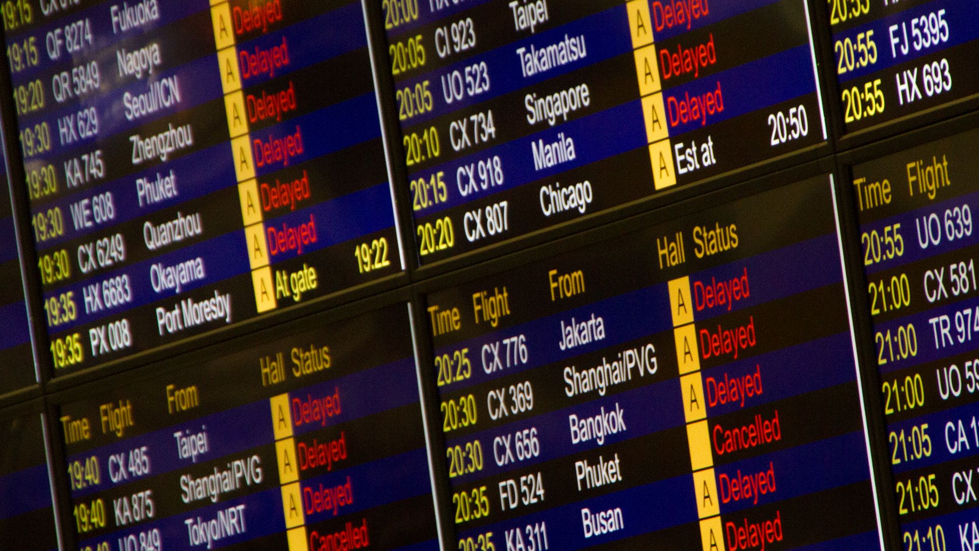 Close-up of digital flight information board showing arrivals and departures at an airport.