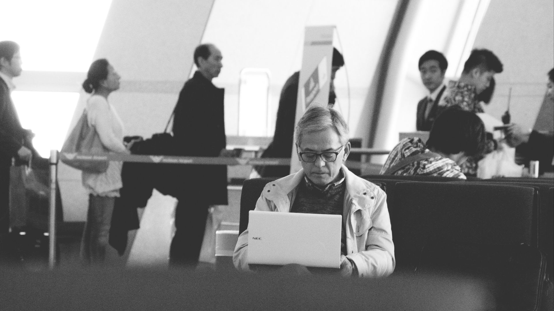 a man sitting at a table using a laptop computer