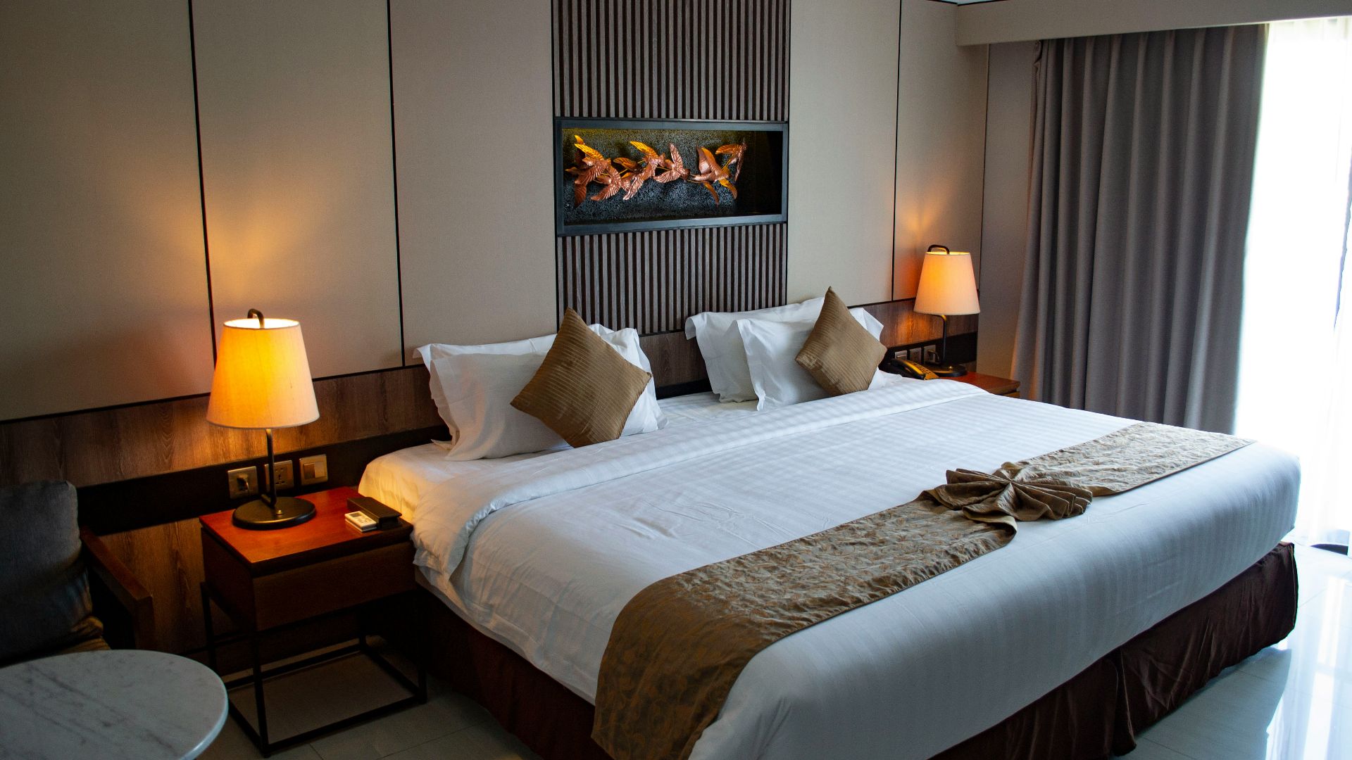 white bed linen with throw pillows