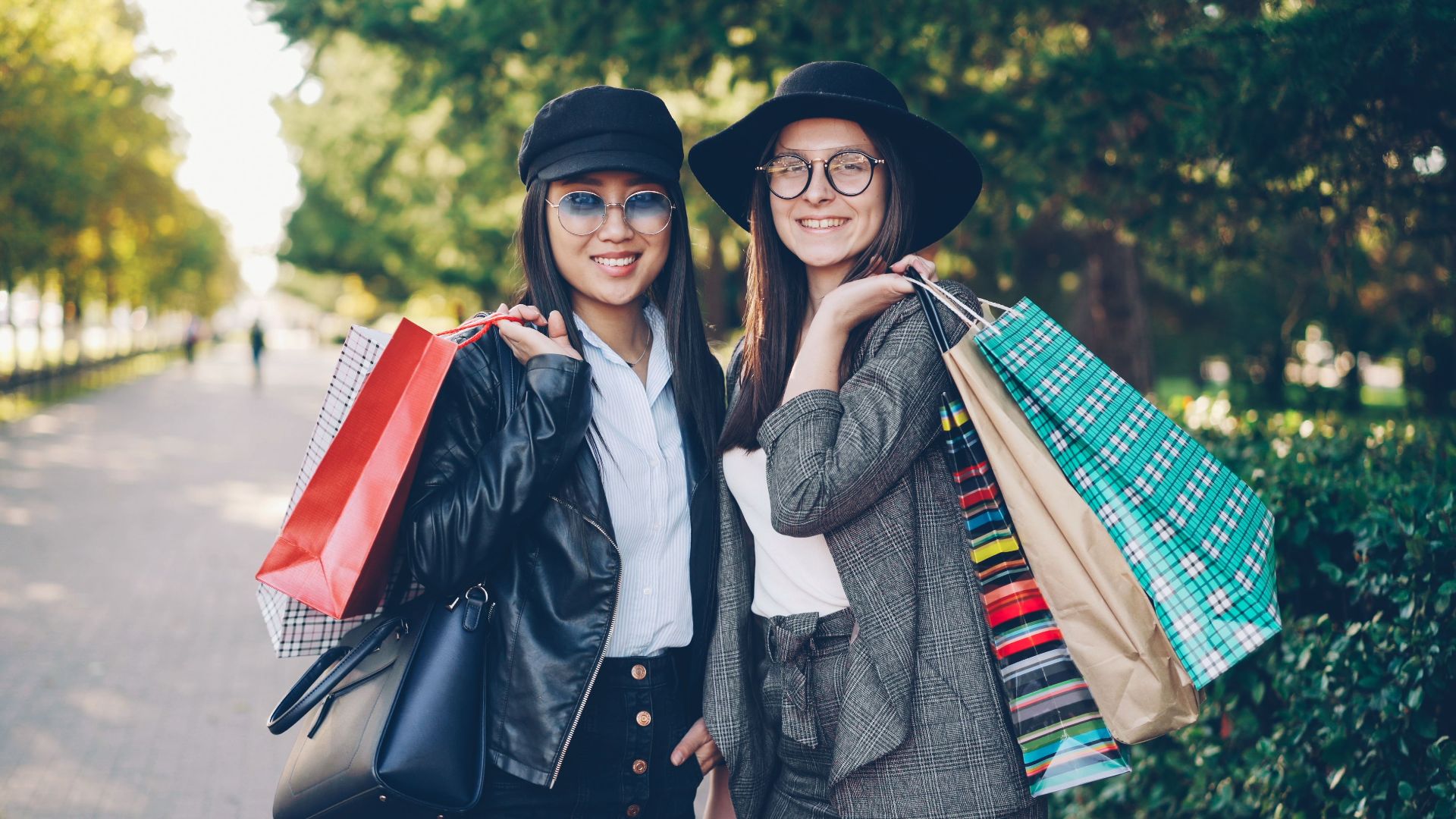 Stylish friends with shopping bags enjoying a day outdoors. Perfect lifestyle concept.