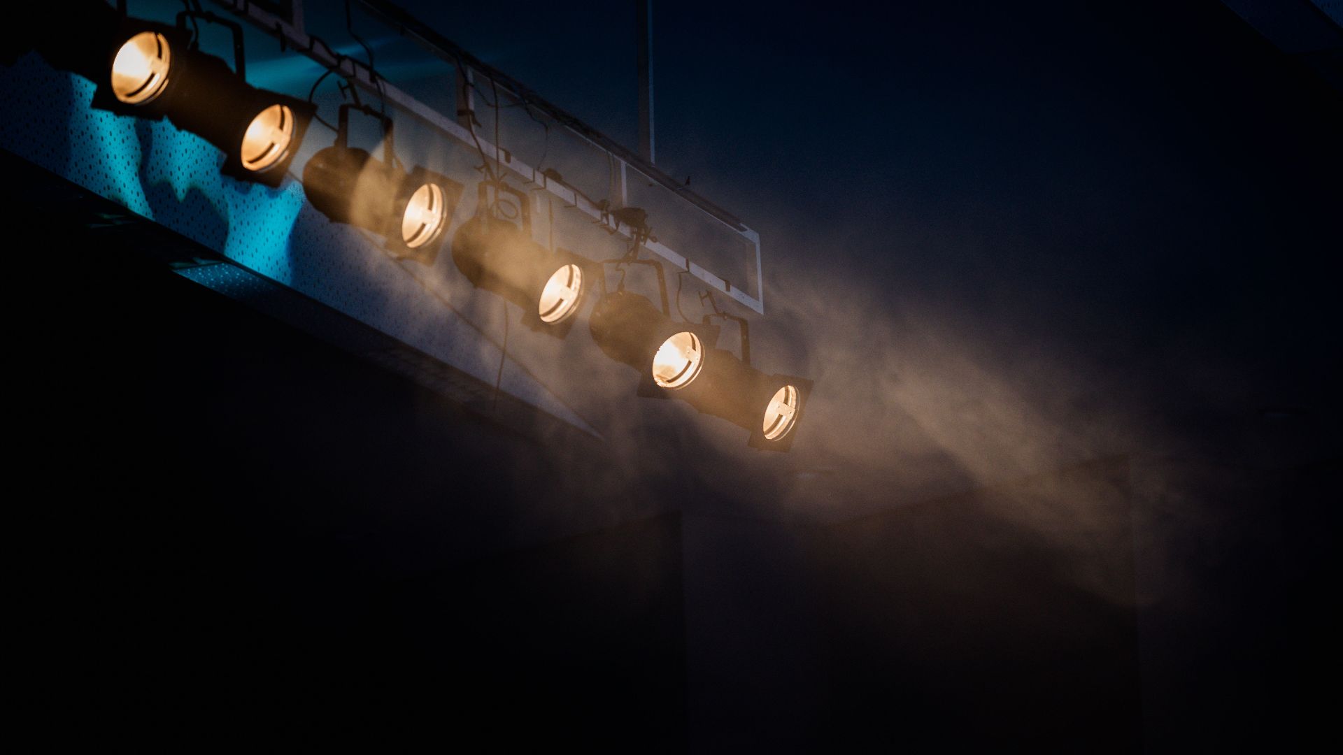 Moody stage lighting with smoke effect to add atmospheric drama.
