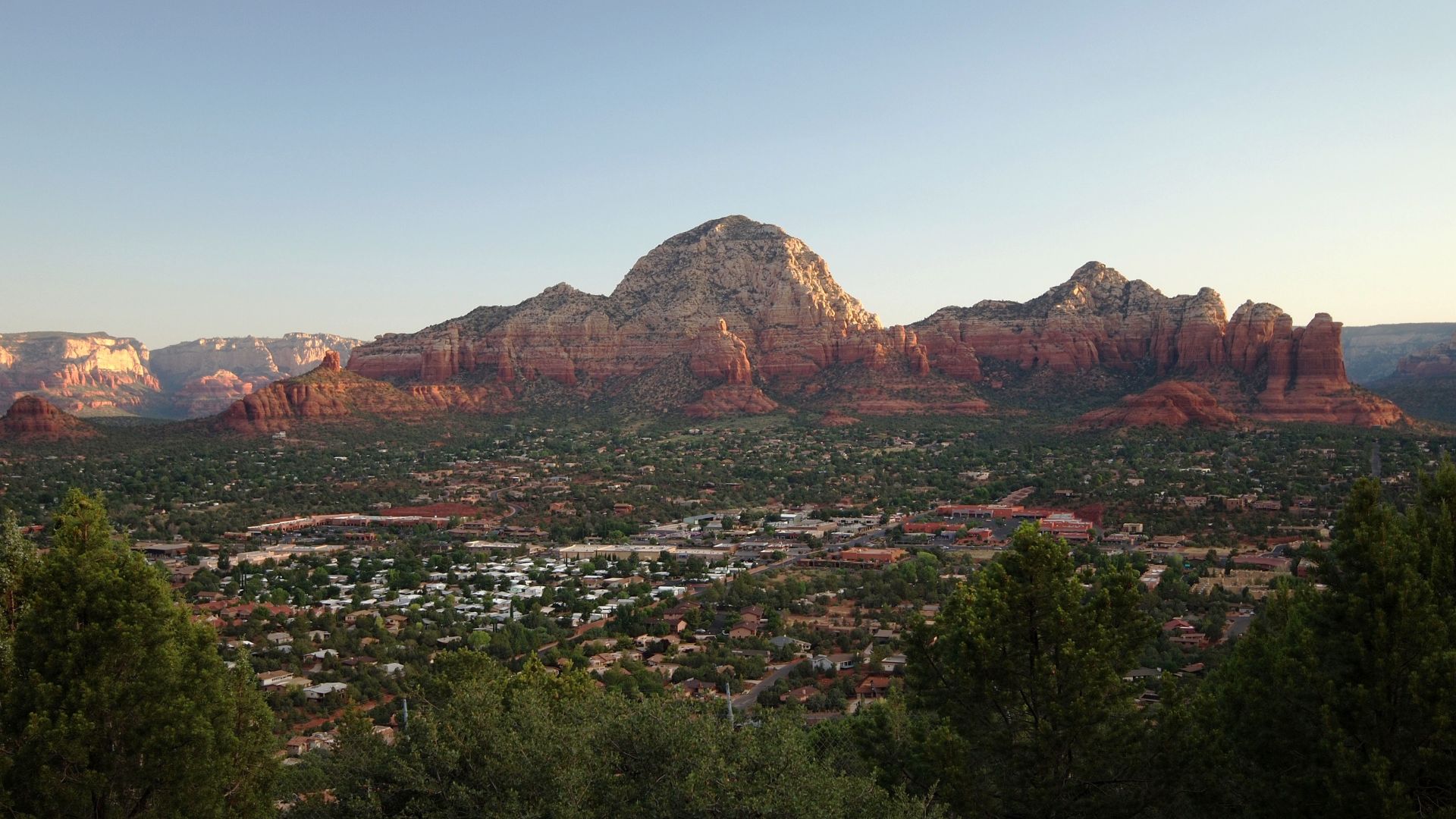 Coffee Pot Rock (right), Capitol Butte (center) and Chimney Rock (left) at sunrise, as seen looking north from the Sky Ranch Lodge on Airport Mesa in Sedona.
Photo taken with an Olympus E-P1 in Yavapai County, AZ, USA.Cropping and post-processing performe