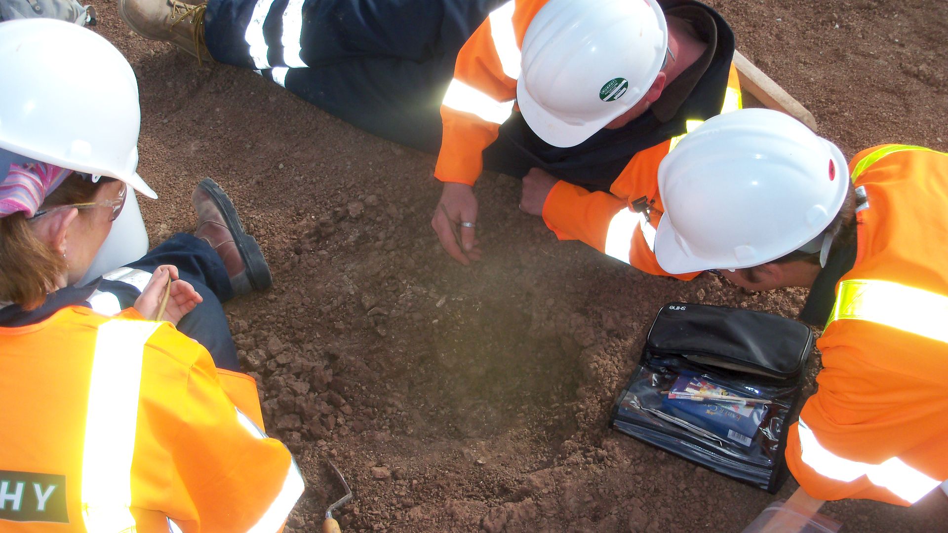 Archaeologists excavating a feature. This is from a development-led archaeology project at the Tirley Feeder Connector, in 2011.