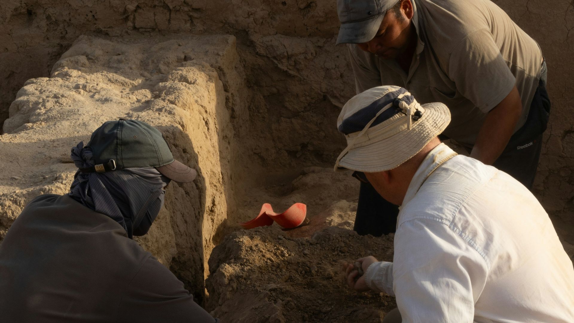 A group of men kneeling down next to each other