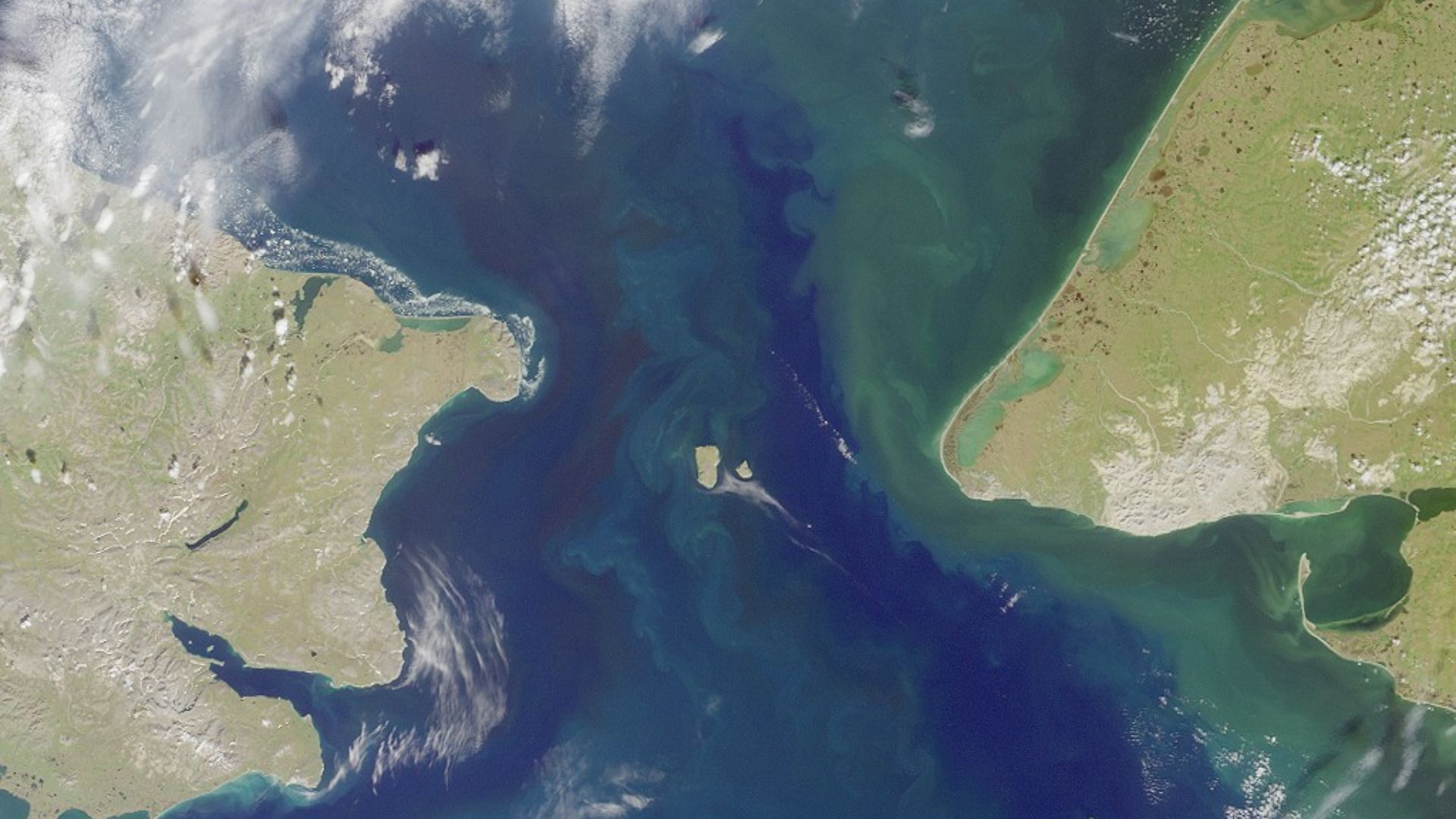 Bering strait, image taken by MISR satellite.

With the Seward Peninsula of Alaska to the east, and Chukotskiy Poluostrovof Siberia to the west, the Bering Strait separates the United States and the Russian Federation by only 90 kilometers. It is named fo