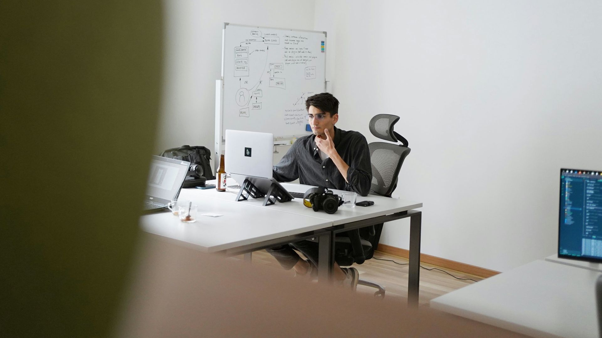 man in black suit sitting on black office rolling chair