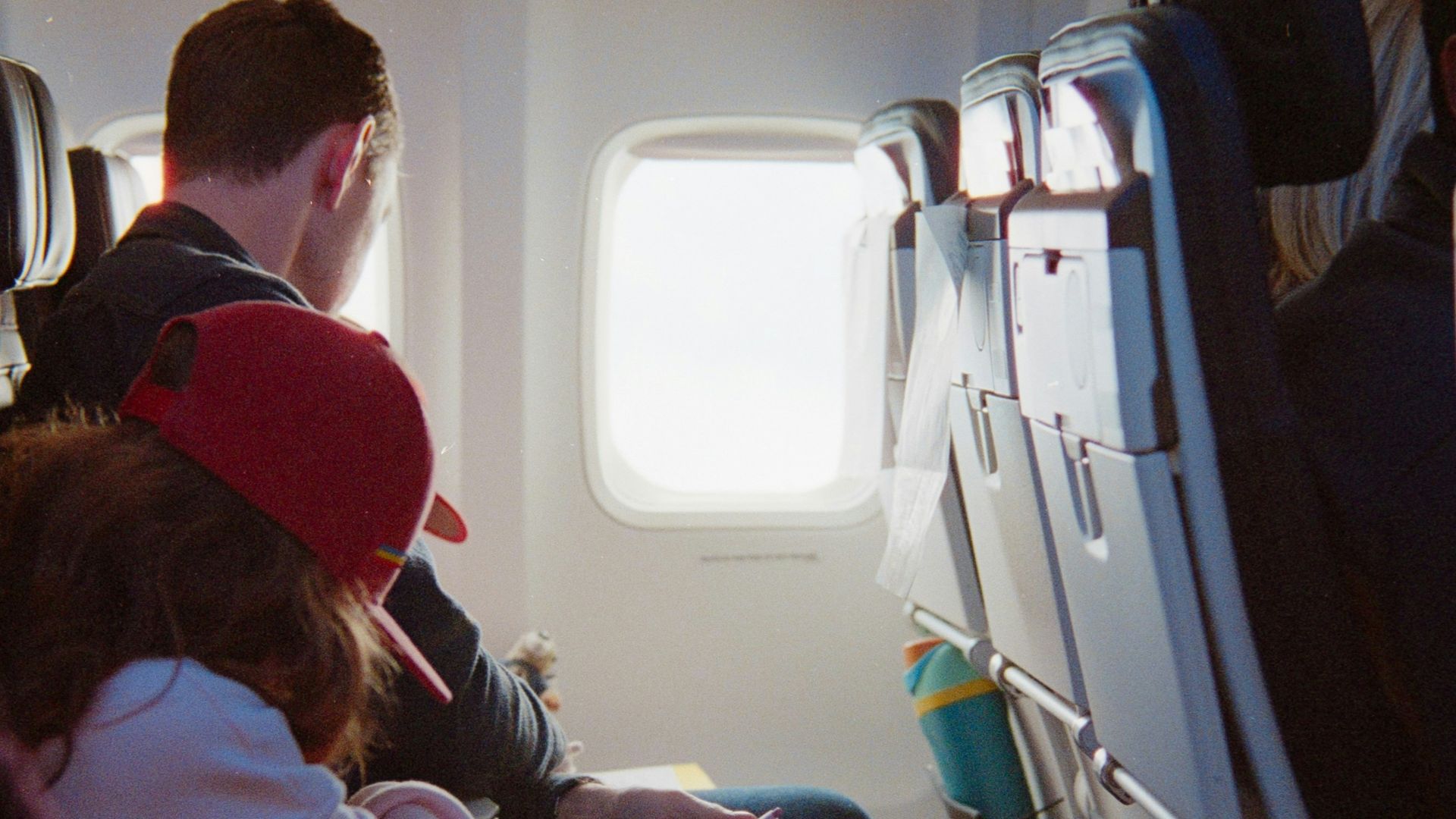 Passengers seated inside an airplane cabin during flight