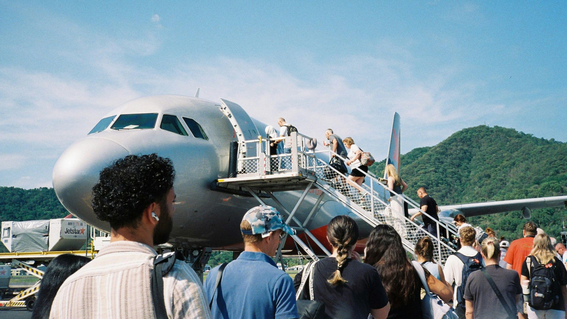 A group of people standing around a plane