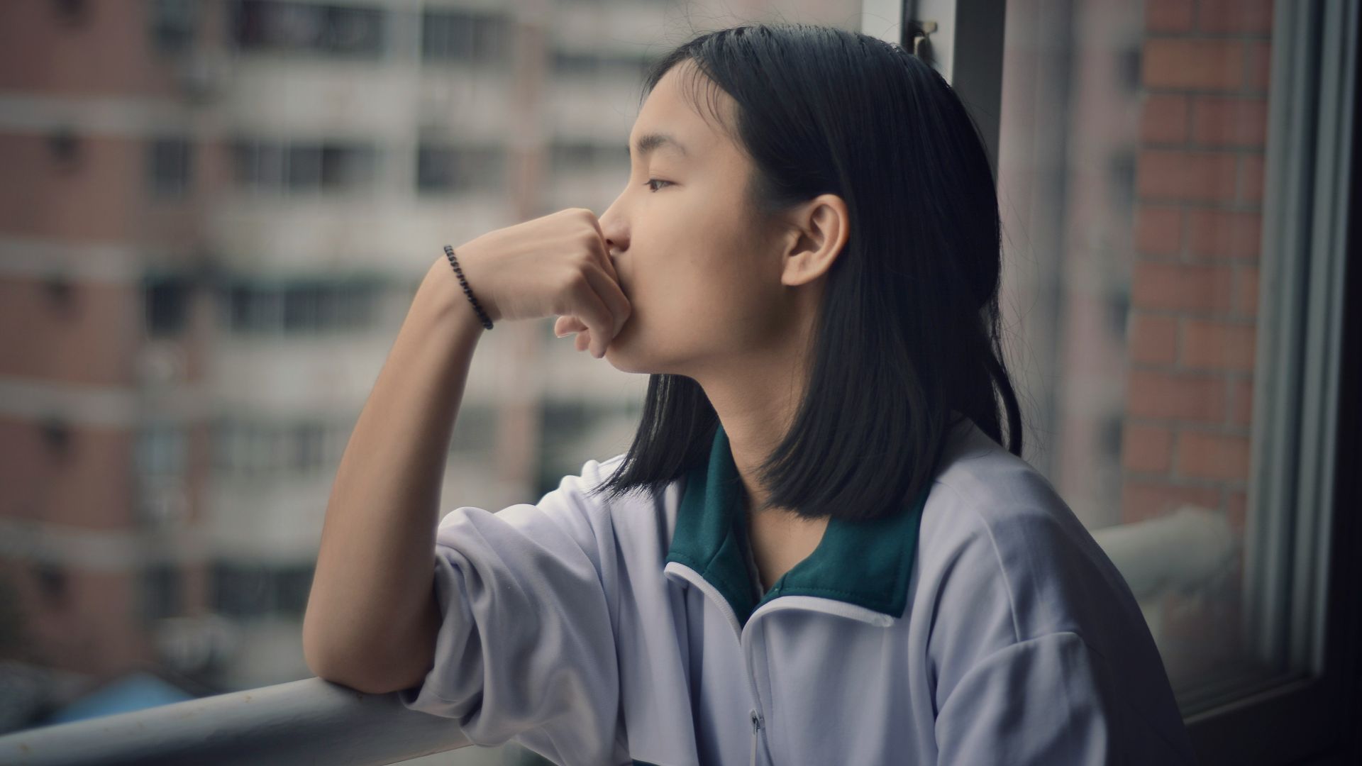 woman looking through window