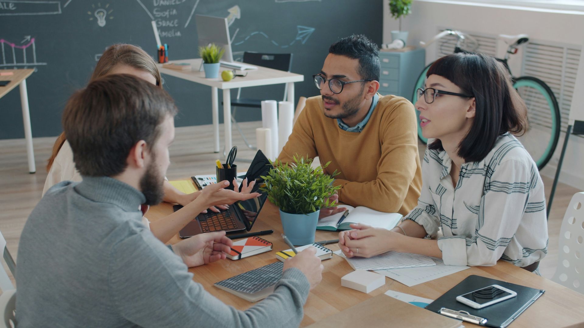 Diverse team collaborating around a table in office