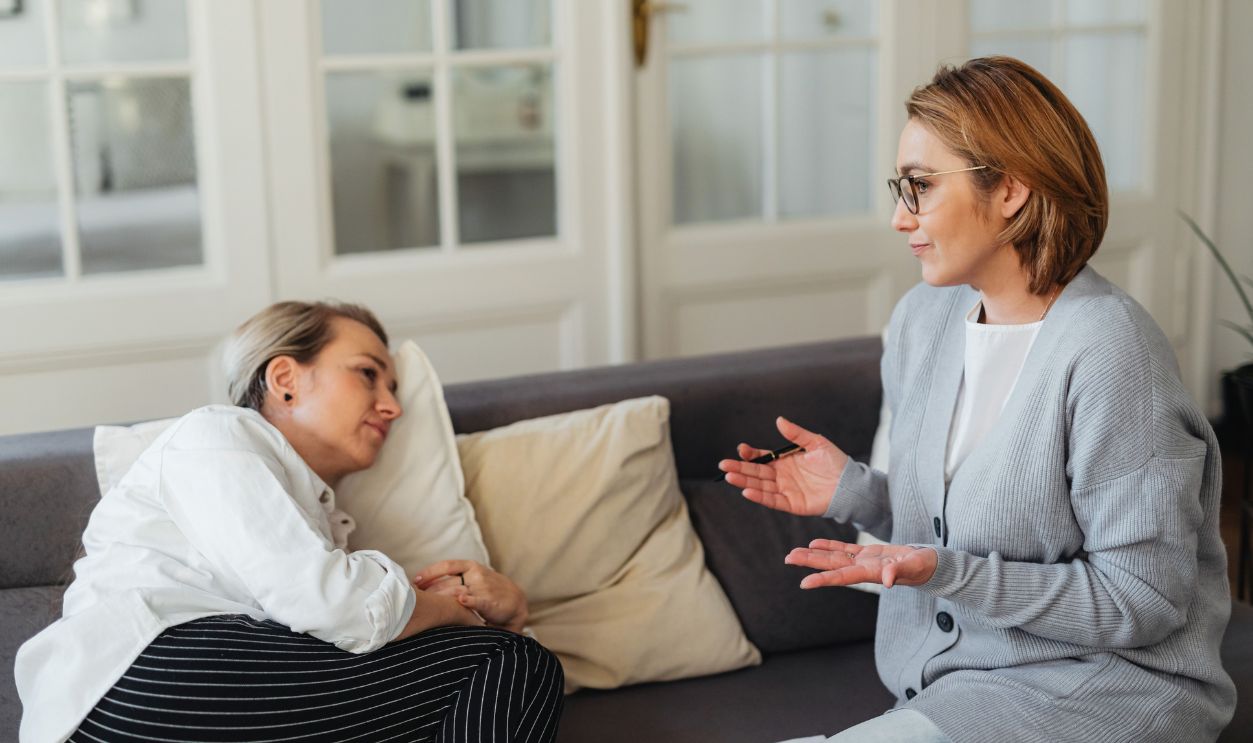Two women sitting on a couch 