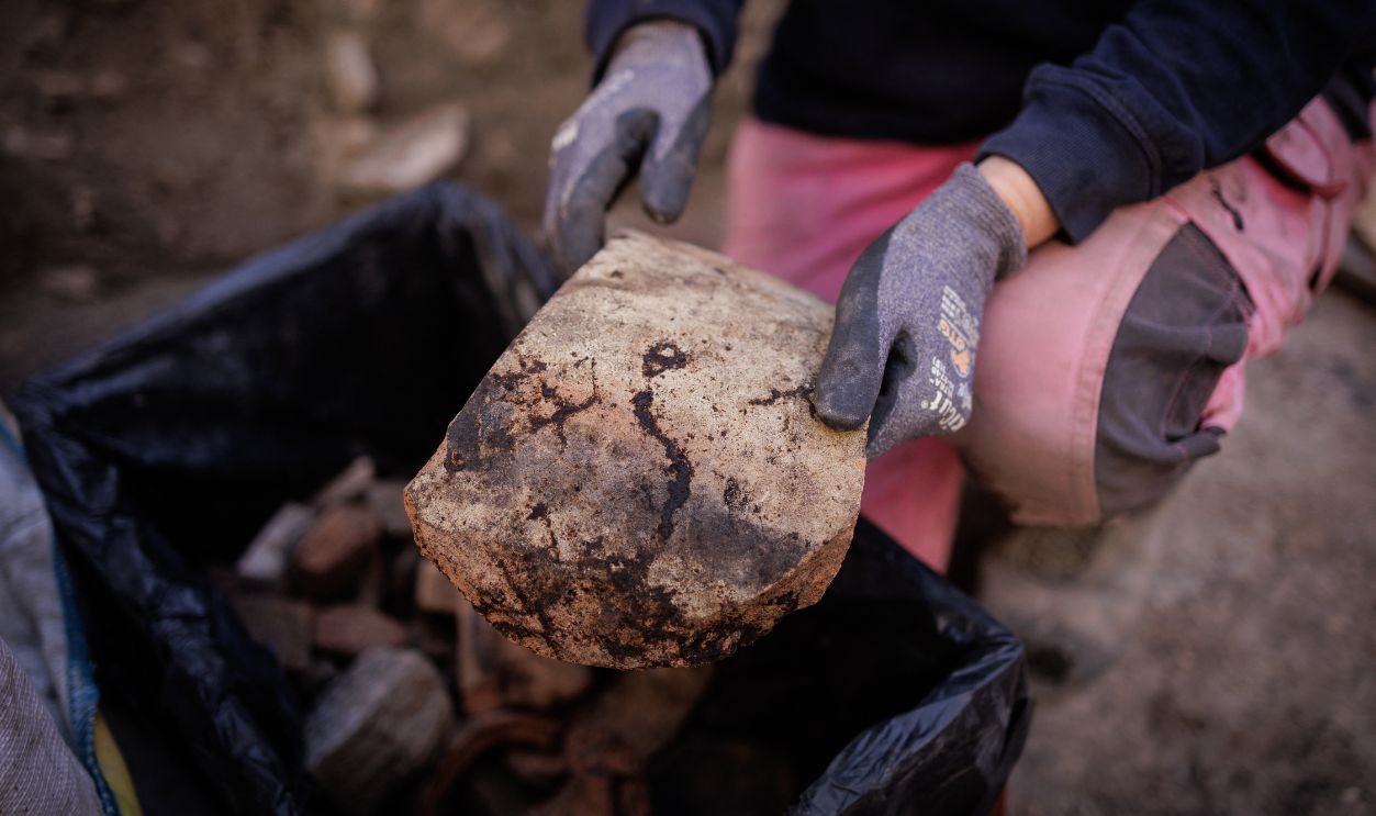 Getty Images - 2296126600 - Elodie Perugini, archeologist for the city of Paris, holds a Gallic wine amphora piece during excavations at an archaeological site under the Hotel-Dieu hospital on the Ile de la Cite in central Paris, on September 23, 2026. A Gallo-Roman era wall of Lutetia was recently discovered at the site.