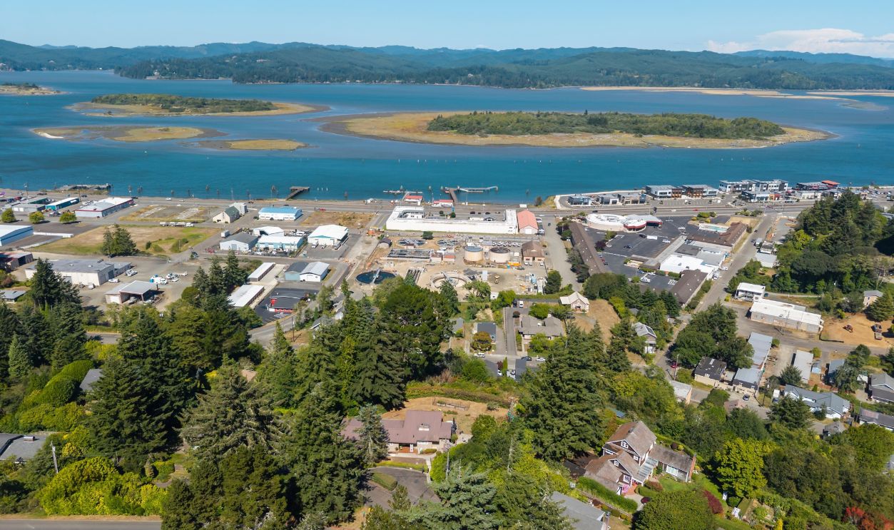 Aerial drone shot of the bay and houses in Coos Bay, Oregon during a summer day with clear sky.