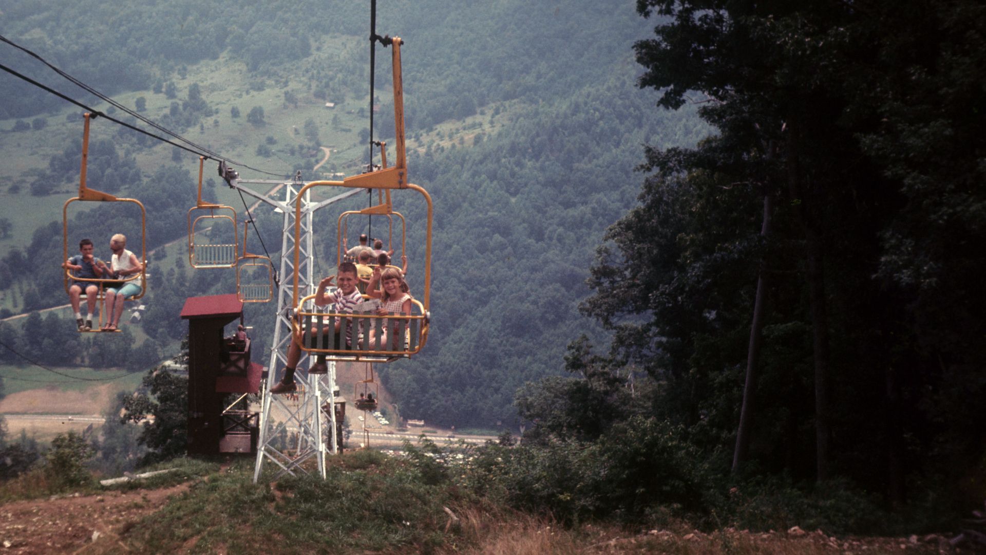 Family vacation photo of the chair lift ride carrying tourists to and from the Maggie Valley Ghost Town tourist attraction in the summer of 1864