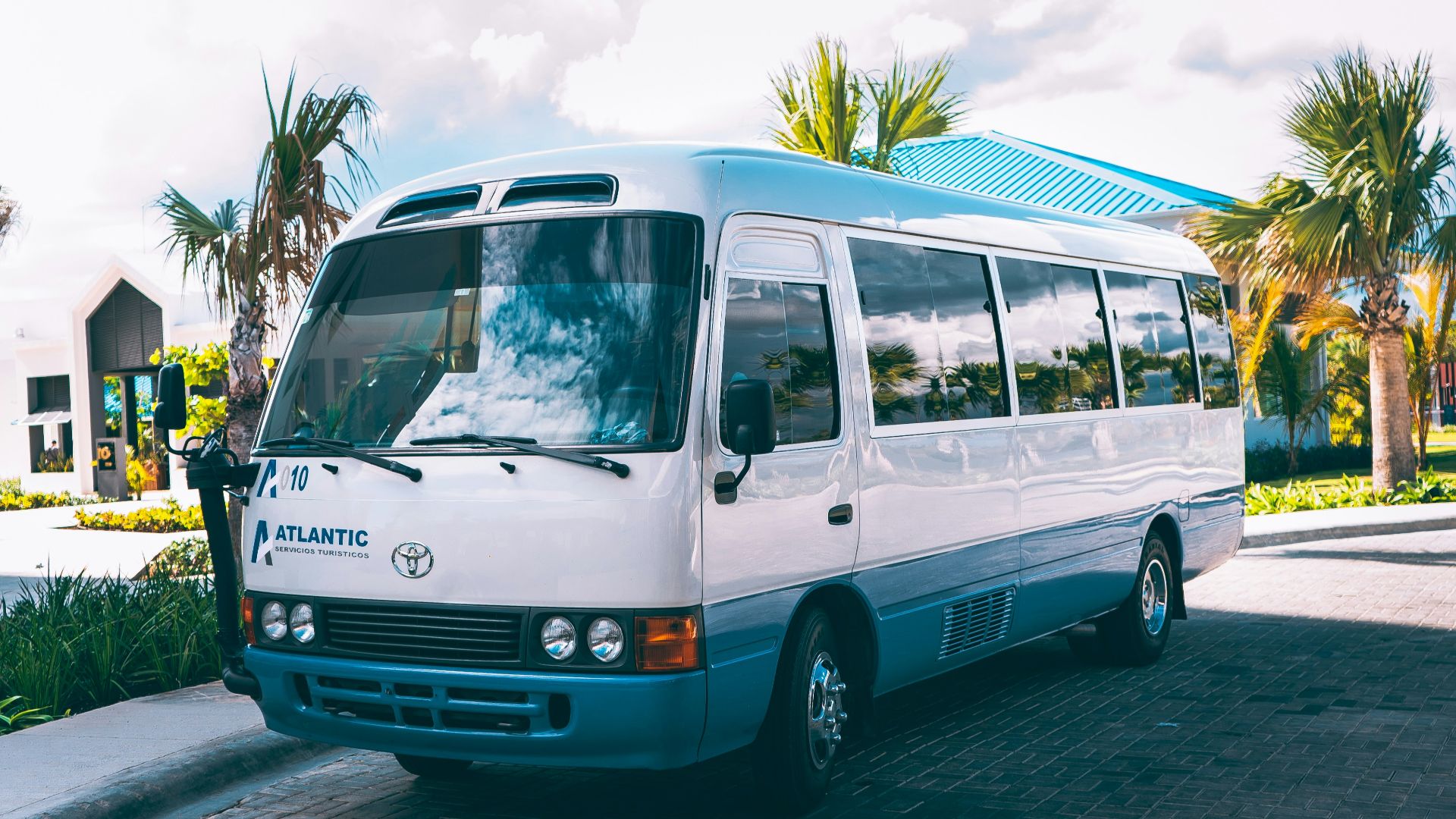 a white bus parked on the side of the road