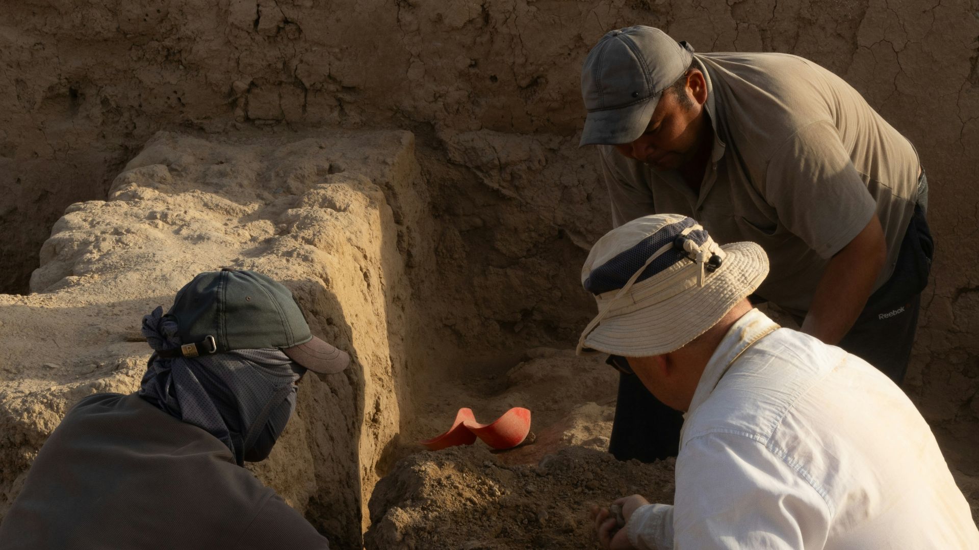 A group of men kneeling down next to each other