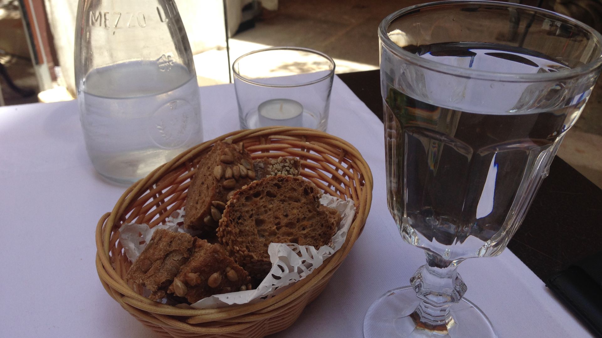 A basket of bread and a goblet of water at La Cour du Louvre, 23 rue Saint Agricol,