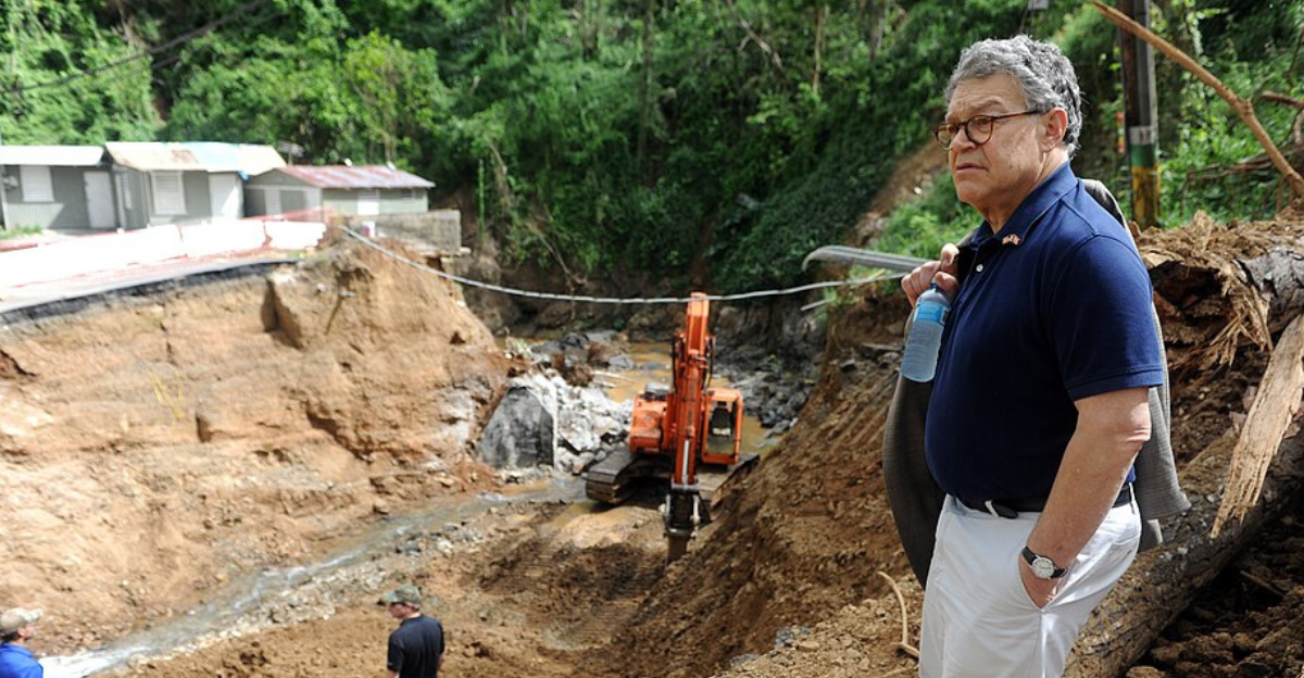 Sen. Al Franken (D-MN) observes the site of a washed out bridge 