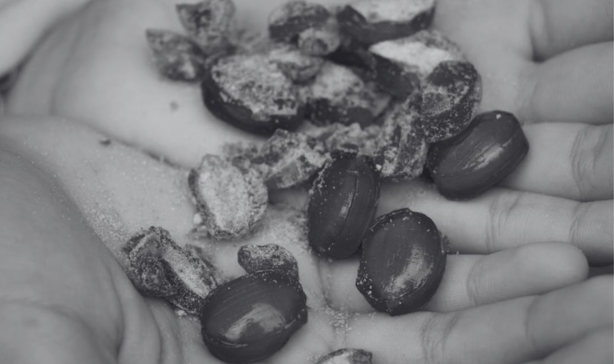 A close-up view of green candies held in hands, showcasing texture and color.