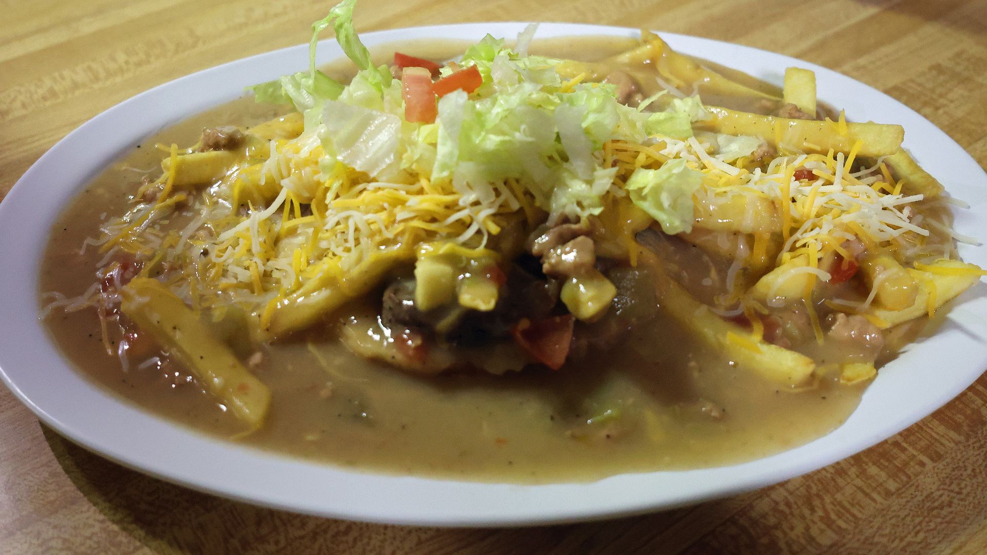 A slopper, a burger (and fries in this case) smothered in chile sauce. This one was served at TC's Diner, located at 284 Highway 10 in Walsenburg, Colorado. The burger was smothered in green chile sauce.