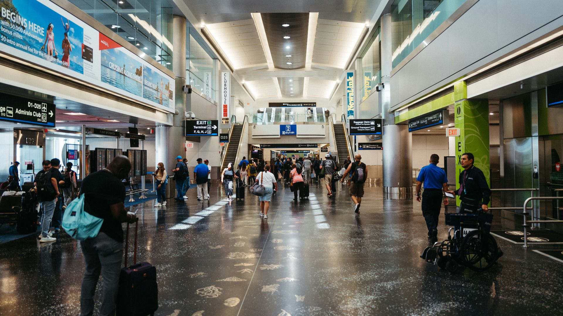 a group of people walking through an airport