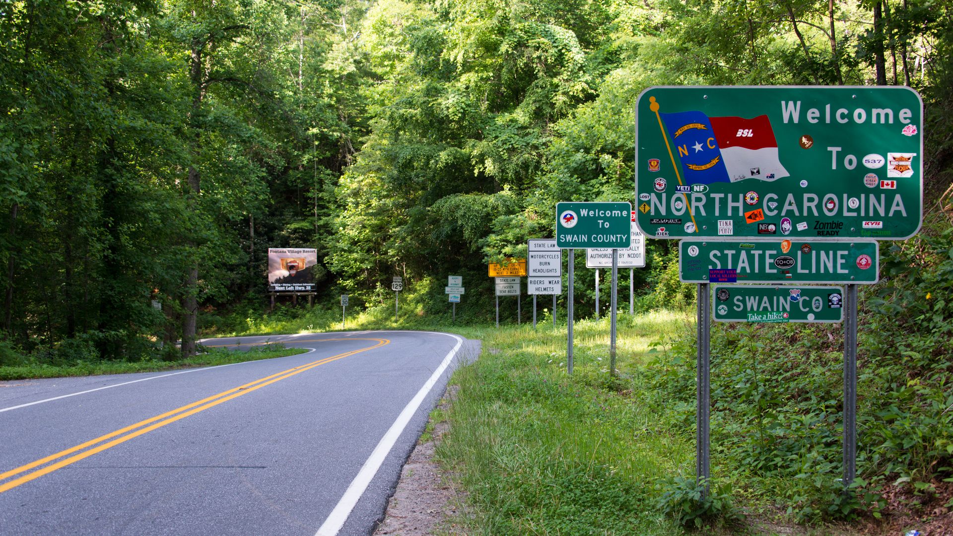 Welcome to North Carolina and other various signs after crossing Deals Gap, from Tennessee.