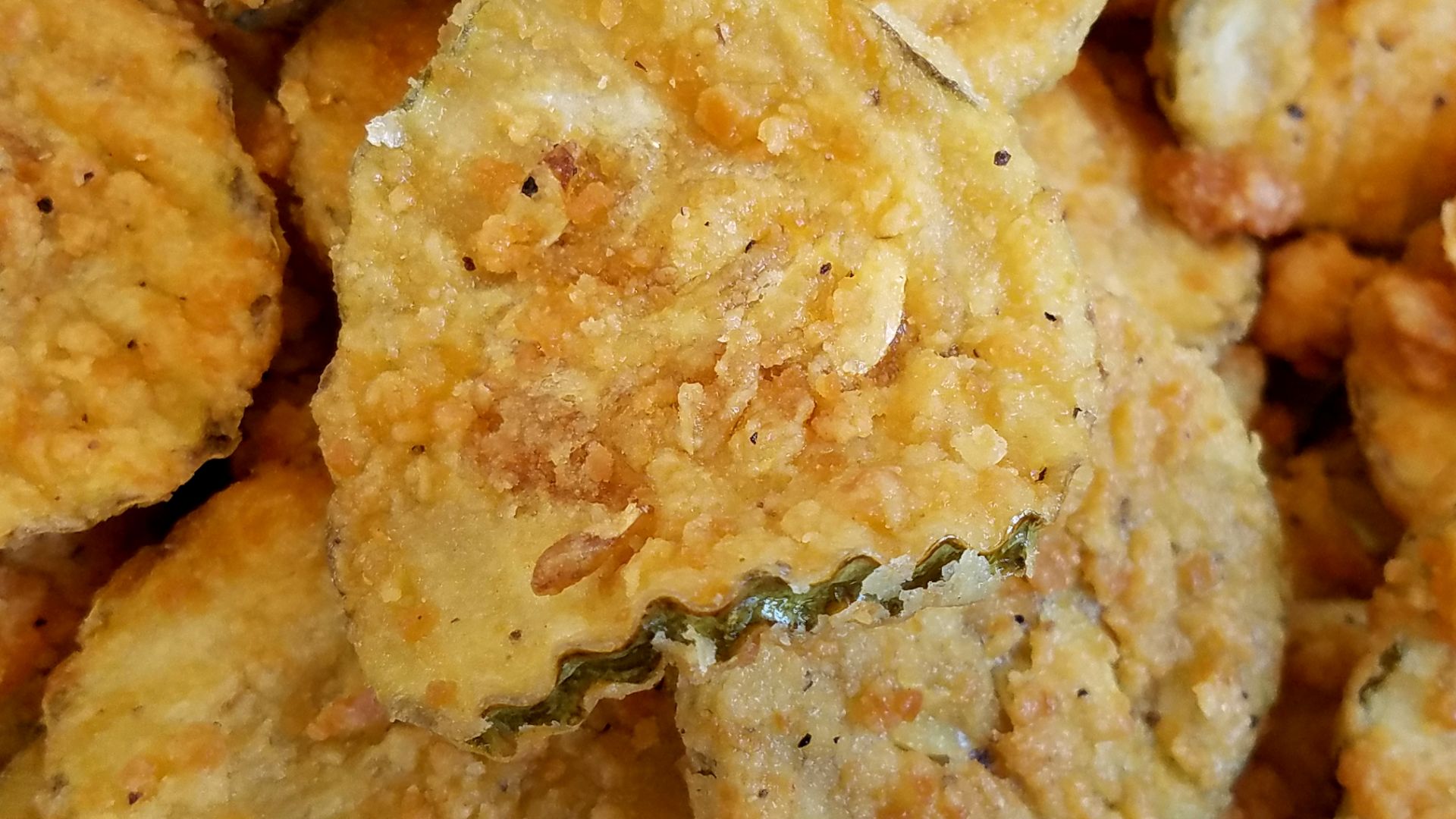 A side of fried pickles from Slim Chickens in Wichita, Kansas. Digitally altered to illustrate fried pickles.