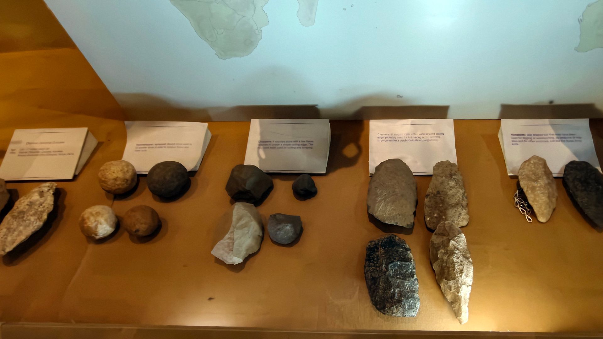 The Oldowan toolkit, the oldest known stone tools dating back at least 2.6 million years, primarily consists of simple hammerstones, stone cores, and sharp flakes used for cutting and chopping.