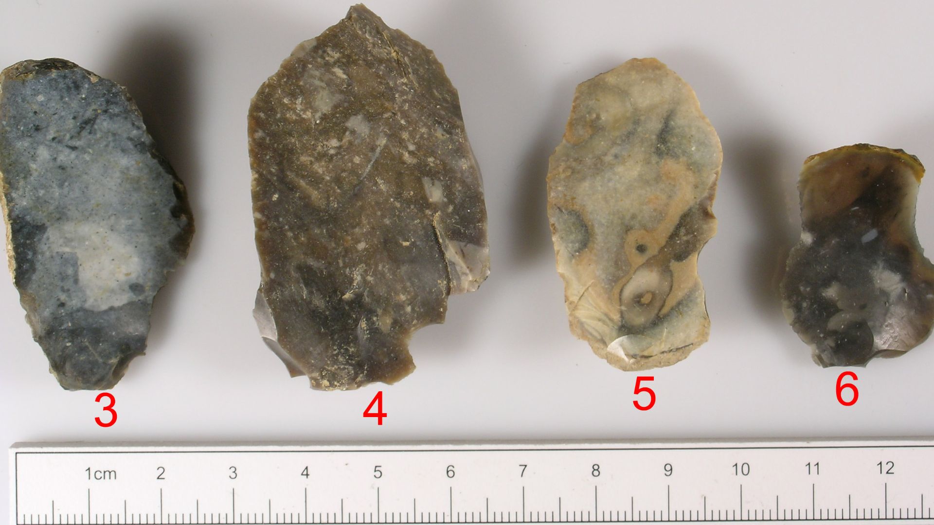 A collection of waste flakes and possible core refreshment flakes from a flint working site. The majority of the usable material appears to have been removed but there are four possible flakes and one large blade (SUSS-5EC274). Some of the 'debitage' also